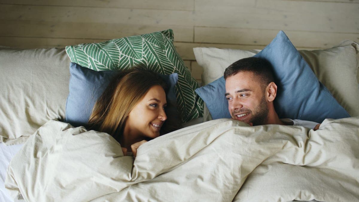 Two pillows side by side on a made bed