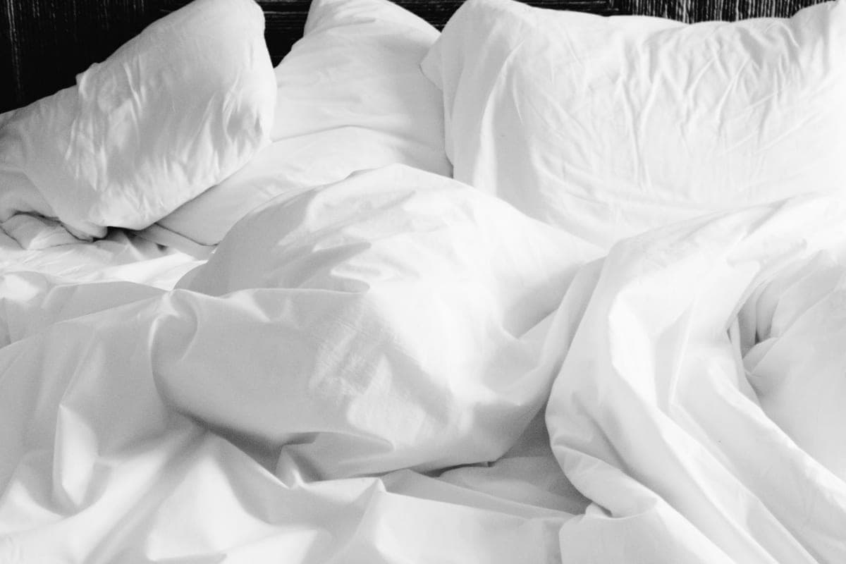 A mattress in a bedroom in morning light