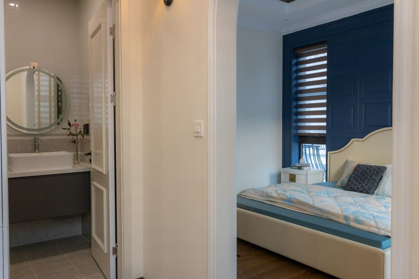 A bare mattress with a fitted sheet pulled back at one corner